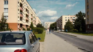 Samochód zaparkowany w Ełku na tle bloków i ulicy w zwykły dzień